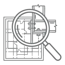 Magnifying glass examining a detailed architectural blueprint floor plan